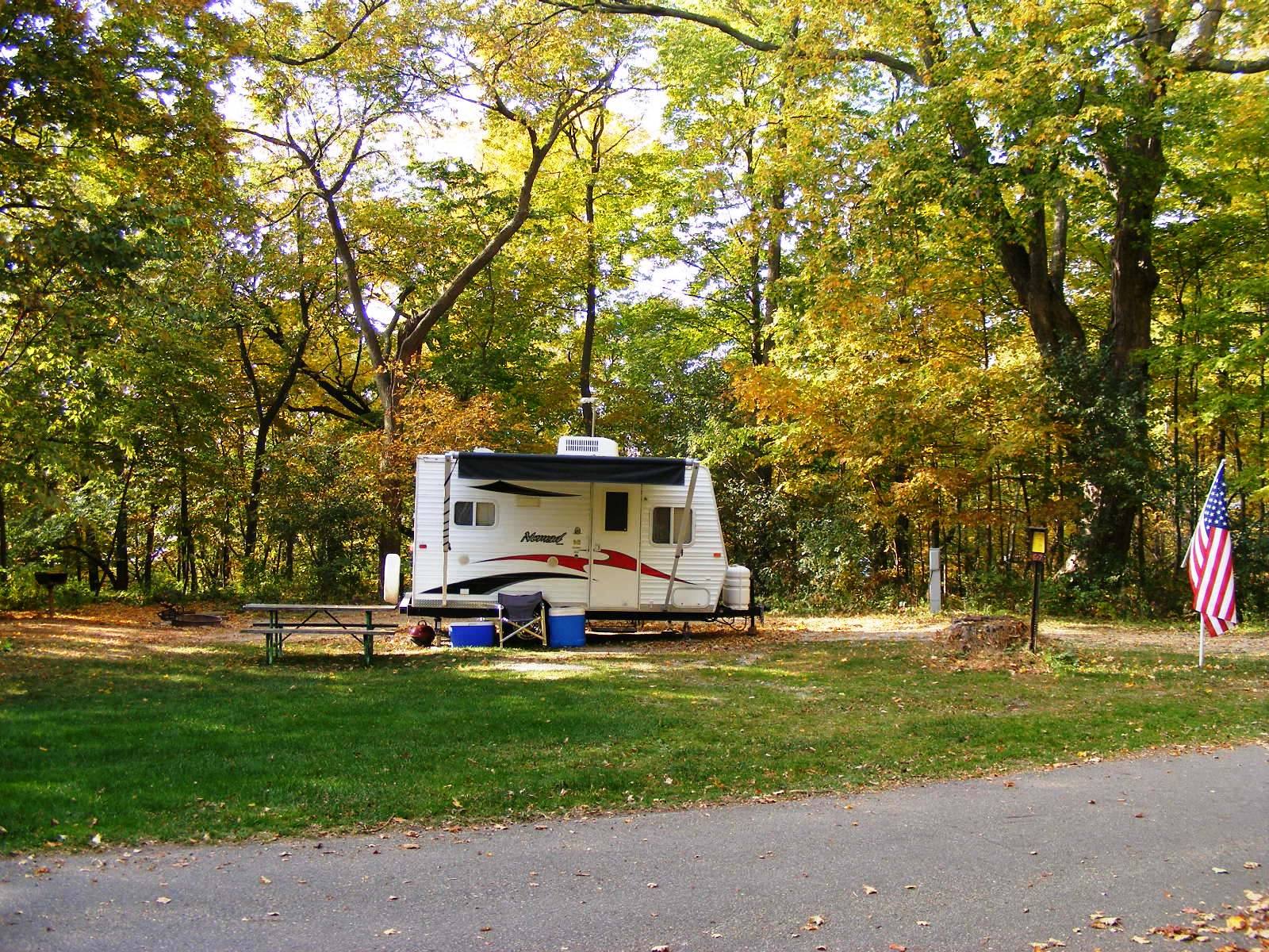 Camper in wooded area.