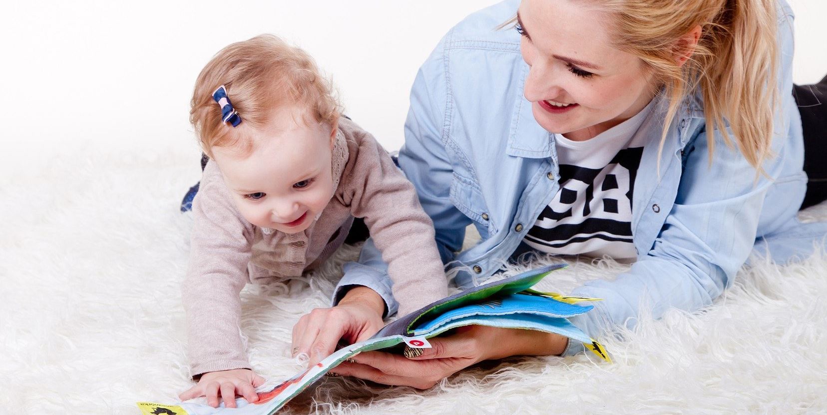 Adult and toddler reading a book